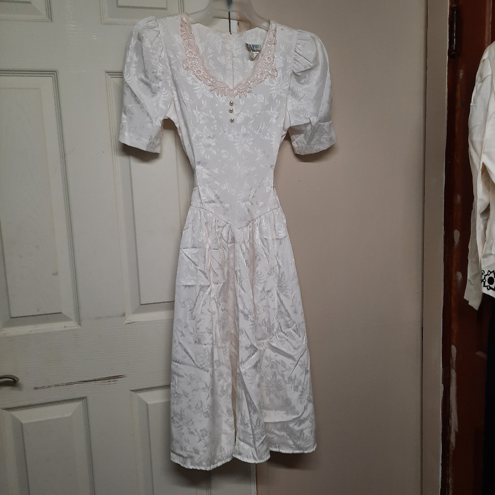 Vintage lace trimmed knee length wedding dress.